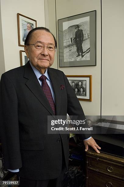 Senate Appropriations Defense Subcommittee Chairman Daniel K. Inouye, D-Hawaii, in front of a picture of himself in France as a U.S. Soldier during...