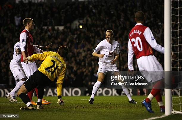 Michael Dawson of Tottenham celebrates as Nicklas Bendtner of Arsenal scores an own goal for Tottenham's 2nd during the Carling Cup Semi-final second...