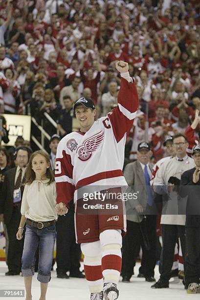 Captain Steve Yzerman of the Detroit Red Wings celebrates as he skates to center ice with his daughter Isabella for the presentation of the Stanley...