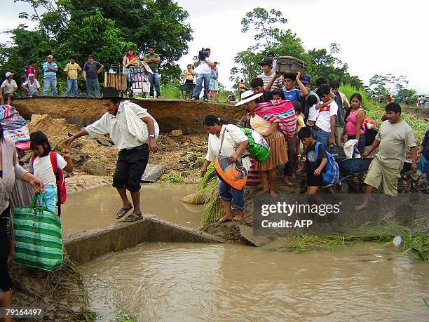 Group of people cross the Ichilo river 22 January in the locality of Poza Azul, some 165km north of Santa Cruz. The Bolivian government decreed on...