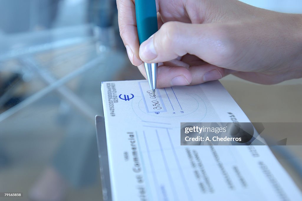 Business person making out check
