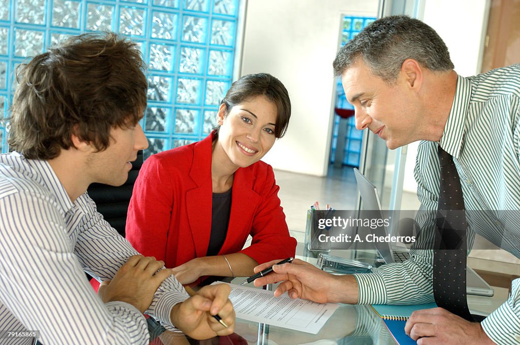 Businessmen and businesswoman in office, smiling