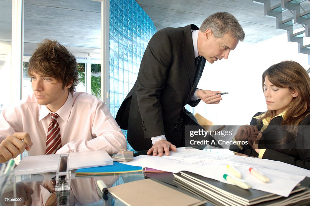 Businessman discussing with colleagues in office