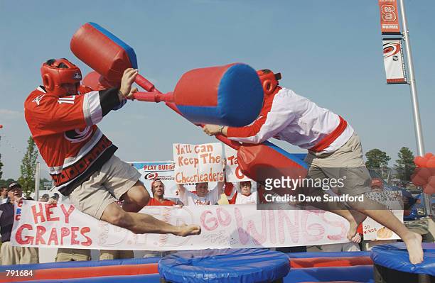 Detroit Red Wings fan and a Carolina Hurricanes fan meet in the parking lot outside the Entertainment Sports Arena for a round of jousting before...