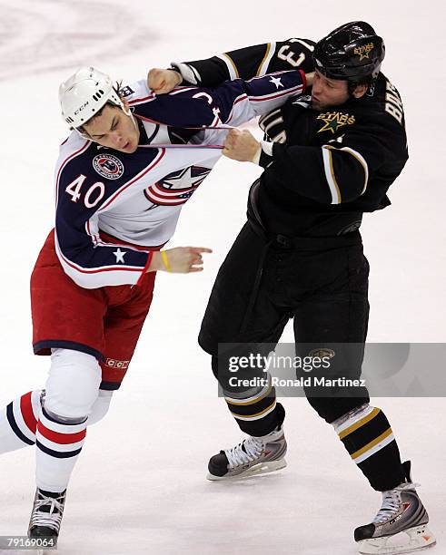 Right wing Jared Boll of the Columbus Blue Jackets fights with Krystofer Barch of the Dallas Stars in the first period at the American Airlines...