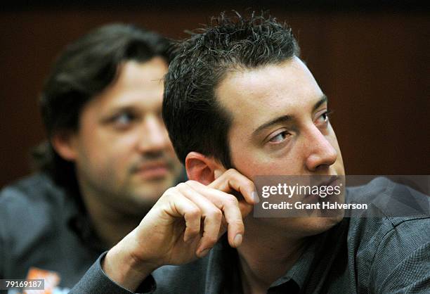 Tony Stewart driver of the Home Depot Camry, and Kyle Busch, driver of the M&M's RAcing Camry, listen during an event at Joe Gibbs Racing January 22,...