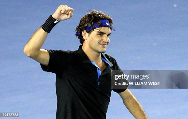 Swiss tennis player Roger Federer gestures as he celebrates victory after his mens singles match against US opponent James Blake at the Australian...