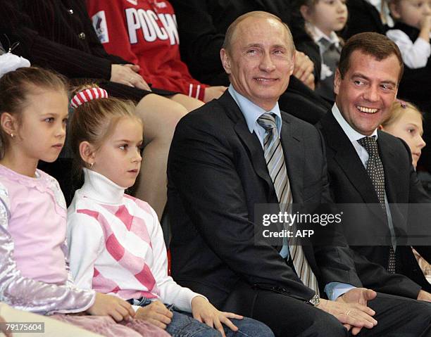 Russian President Vladimir Putin and First Deputy Prime Minister and presidential candidate Dmitry Medvedev smile during their visit to the sport...