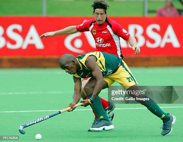 Lungile Tsolekile of South Africa controls the ball as Jan Marc Montag of Germany loses his stick during the Five Nations Mens Hockey tournament...