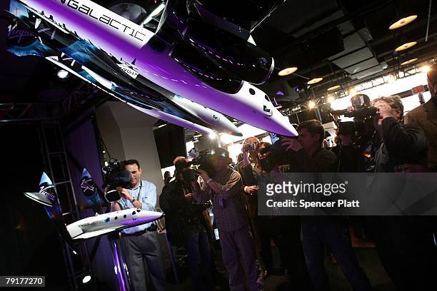 Members of the media photograph a model spaceship designed with financial assistance from Richard Branson at a news conference January 23, 2008 in...