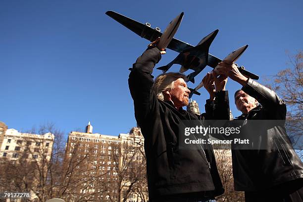 Sir Richard Branson of Virgin Atlantic and designer Burt Rutan hold up a model of a spaceship unveiled at a news conference January 23, 2008 in New...