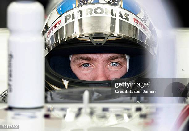 Nick Heidfeld of Germany and team BMW Sauber waits in his car inside the team's garage during Formula one testing at the Ricardo Tormo racetrack on...