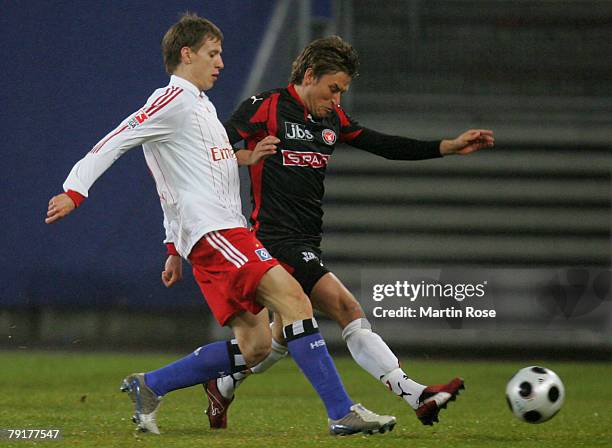 Anton Putsilo of Hamburg and Christopher Poulsen of Midtjyland compete for the ball during the friendly match between Hamburger SV and FC Midtjyland...