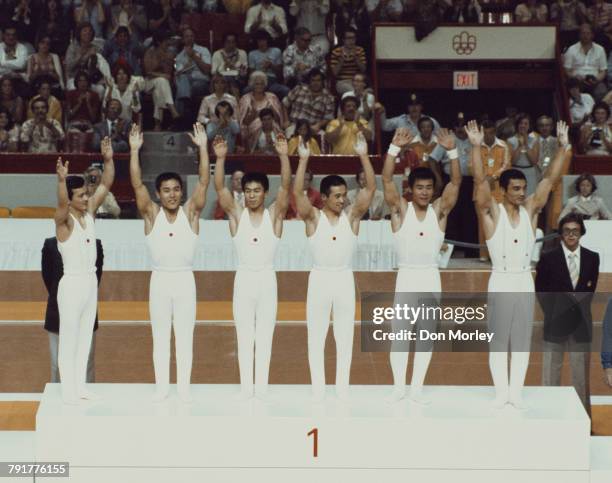 Sawao Kato, Mitsuo Tsukahara, Hiroshi Kajiyama, Eizo Kenmotsu, Hisato Igarashi and Shun Fujimoto of Japan stand on the podium after winning the Men's...