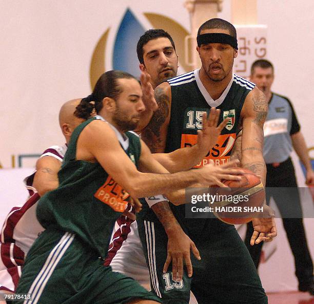 Mike Brand of Lebanon's Sagesse club passes the ball to Sabah Khory during a basketball match against Iran's Mohram club at the 19th Dubai...