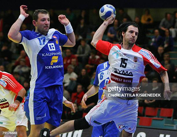 Hungary's left wing Szabolcs Toro shoots after avoiding Iceland's pivot Sverre Jakobsson during their 8th Men's European Handball Championship Main...