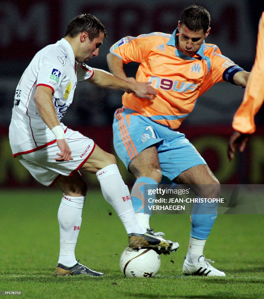 Nancy's defender David Sauget (L) fights