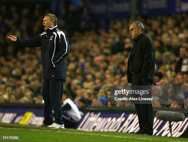 Avram Grant the manager of Chelsea looks on as David Moyes the manager of Everton shouts directions to his players during the Carling Cup Semi Final...