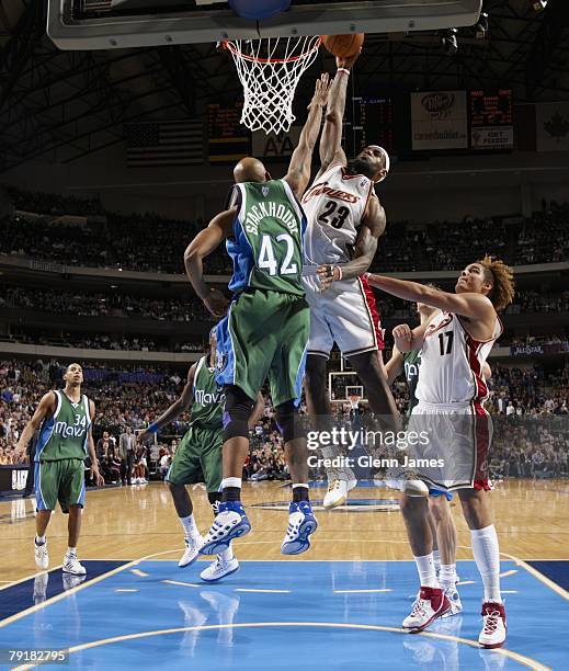 LeBron James of the Cleveland Cavaliers dunks against Jerry Stackhouse of the Dallas Mavericks during the game at the American Airlines Center on...