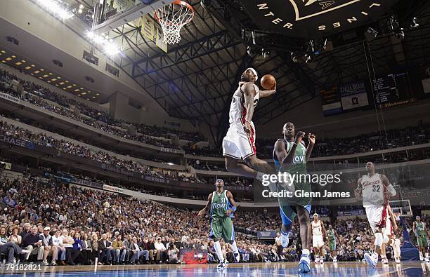 LeBron James of the Cleveland Cavaliers goes up for dunk past DeSagana Diop of the Dallas Mavericks during the game at the American Airlines Center...