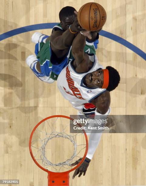 Gerald Wallace of the Charlotte Bobcats shoots against DeSagana Diop of the Dallas Mavericks on January 23, 2008 at the Charlotte Bobcats Arena in...