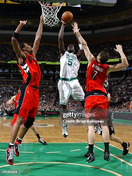 Kevin Garnett of the Boston Celtics takes a shot against Andrea Bargnani and Chris Bosh of the Toronto Raptors on January 23, 2008 at the TD...