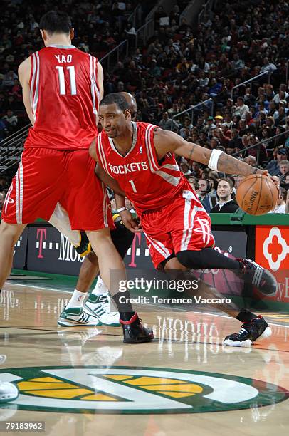 Tracy McGrady of the Houston Rockets drives pat the defense of Damien Wilkins of the Seattle SuperSonics on January 23, 2008 at the Key Arena in...