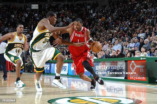Tracy McGrady of the Houston Rockets drives against the defense of Kevin Durant of the Seattle SuperSonics on January 23, 2008 at the Key Arena in...