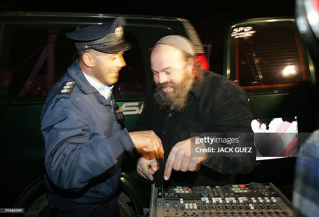 An Israeli policeman asks an ultra-Ortho