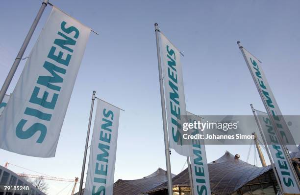 Flags of Siemens global powerhouse in electronics and electrical engineering are seen prior to the annual shareholder meeting at Olympiahalle on...