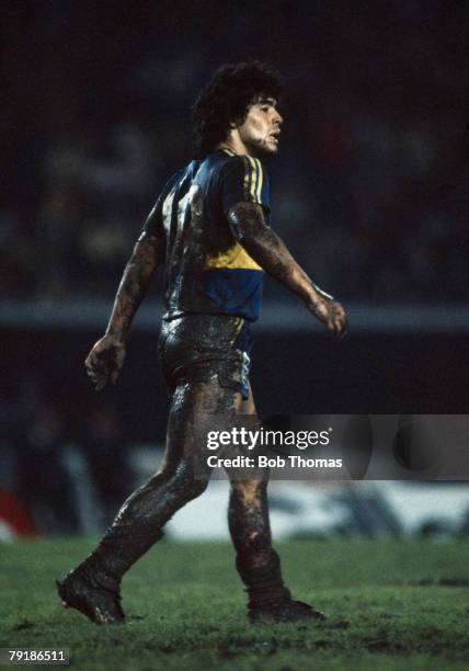 Boca Juniors striker Diego Maradona covered in mud during a match against Racing Club, 14th May 1981.