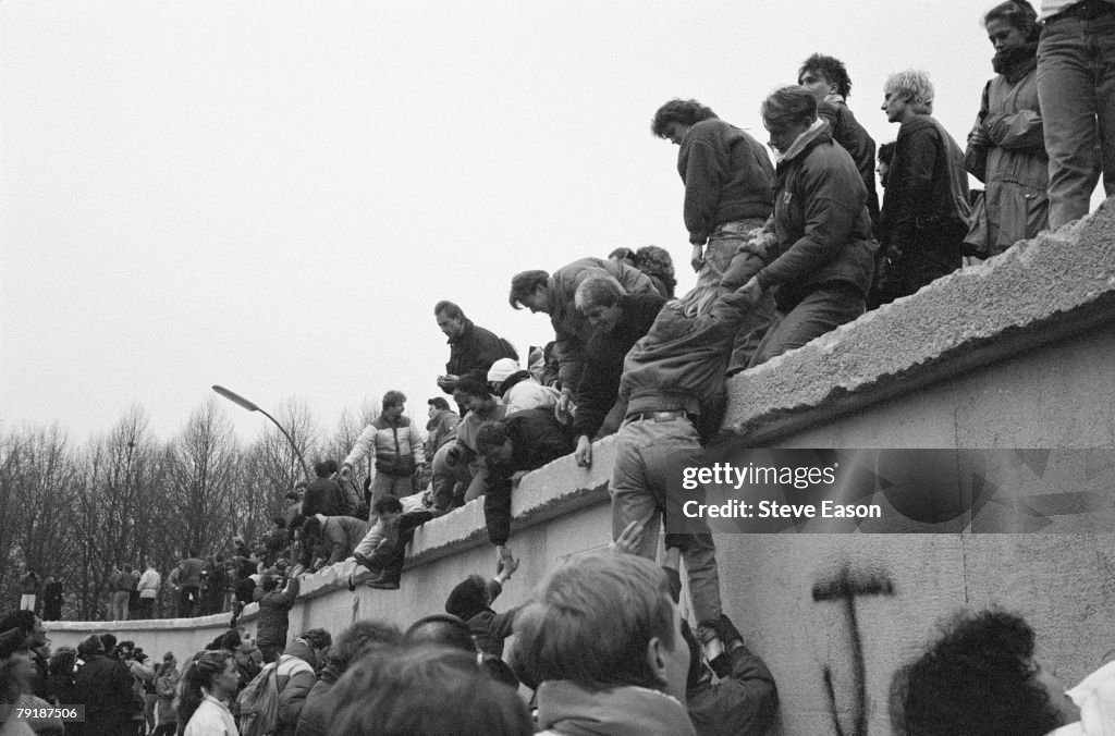 East Berliners Climb Wall