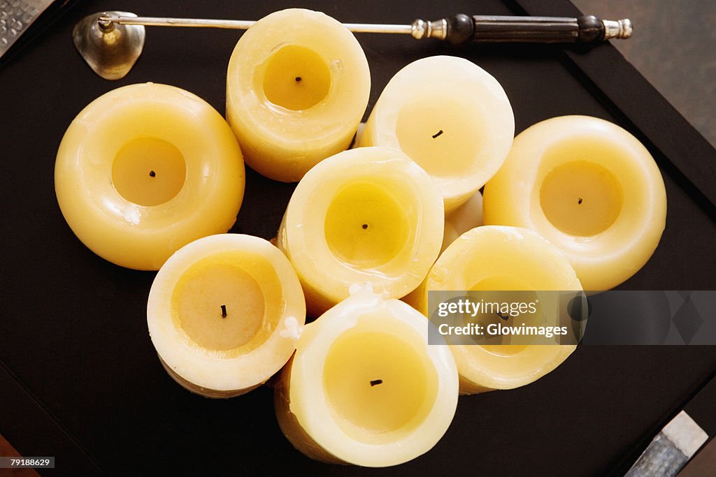 High angle view of candles with a bell in a tray