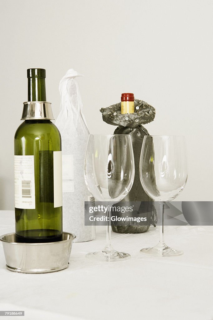 Wine bottles and two wine glasses on a dining table