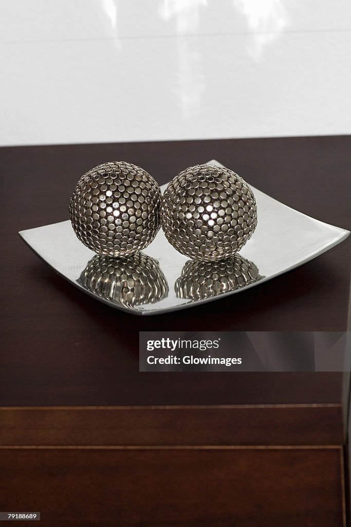 Close-up of two decorative balls in a tray