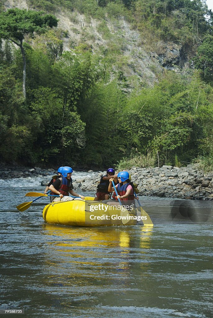 Four people rafting in a river