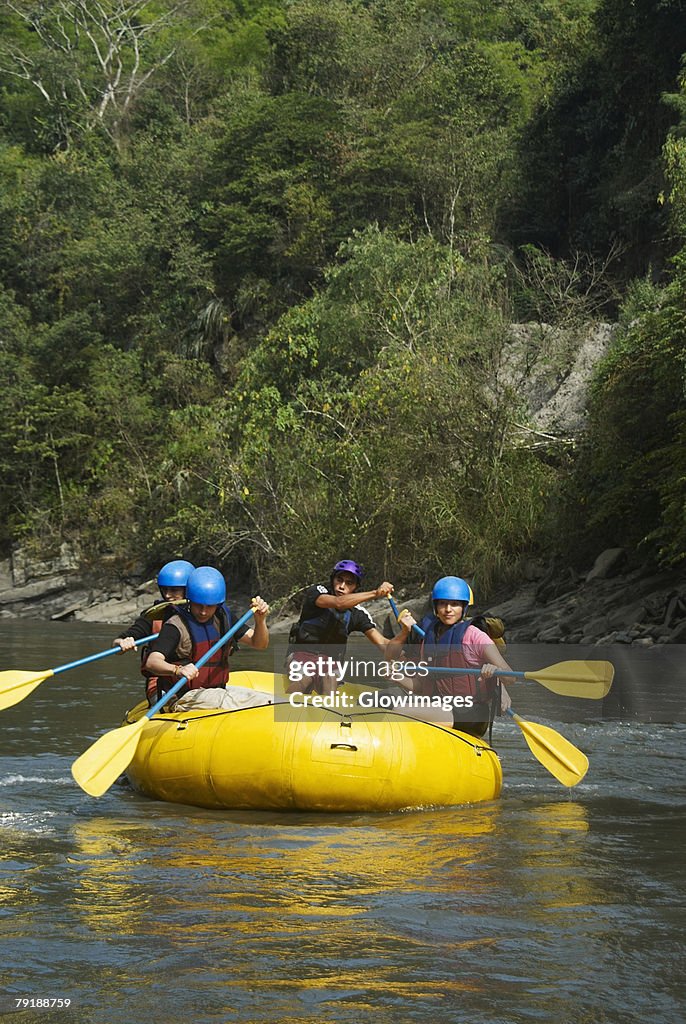 Five people rafting in a river