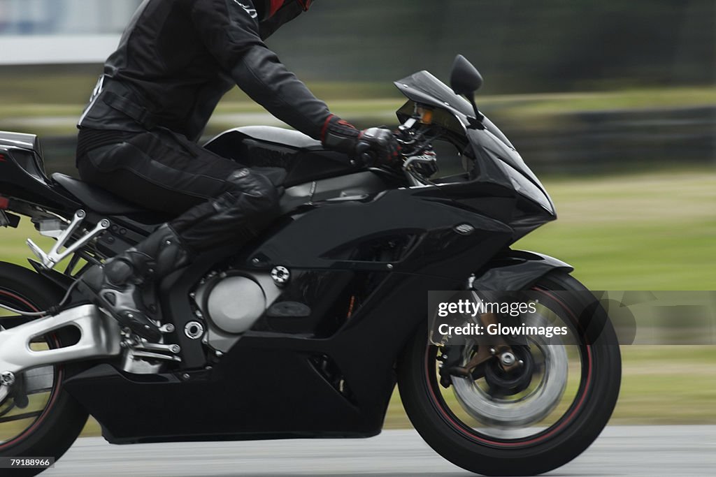 Side profile of a person riding a motorcycle