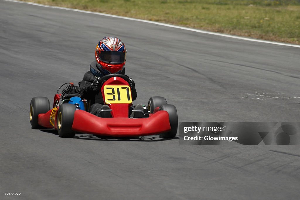 Person go-carting on a motor racing track