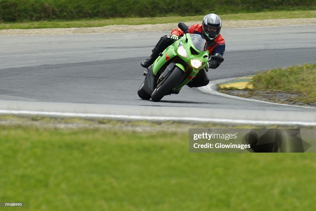Person riding a motorcycle on a motor racing track
