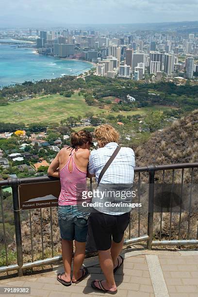rear view of a man and a woman standing at an observation point, diamond head, waikiki beach, honolulu, oahu, hawaii islands, usa - hawaii observatory stock pictures, royalty-free photos & images