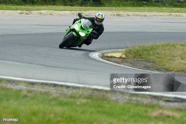 person riding a motorcycle on a motor racing track - motor racing track stockfoto's en -beelden
