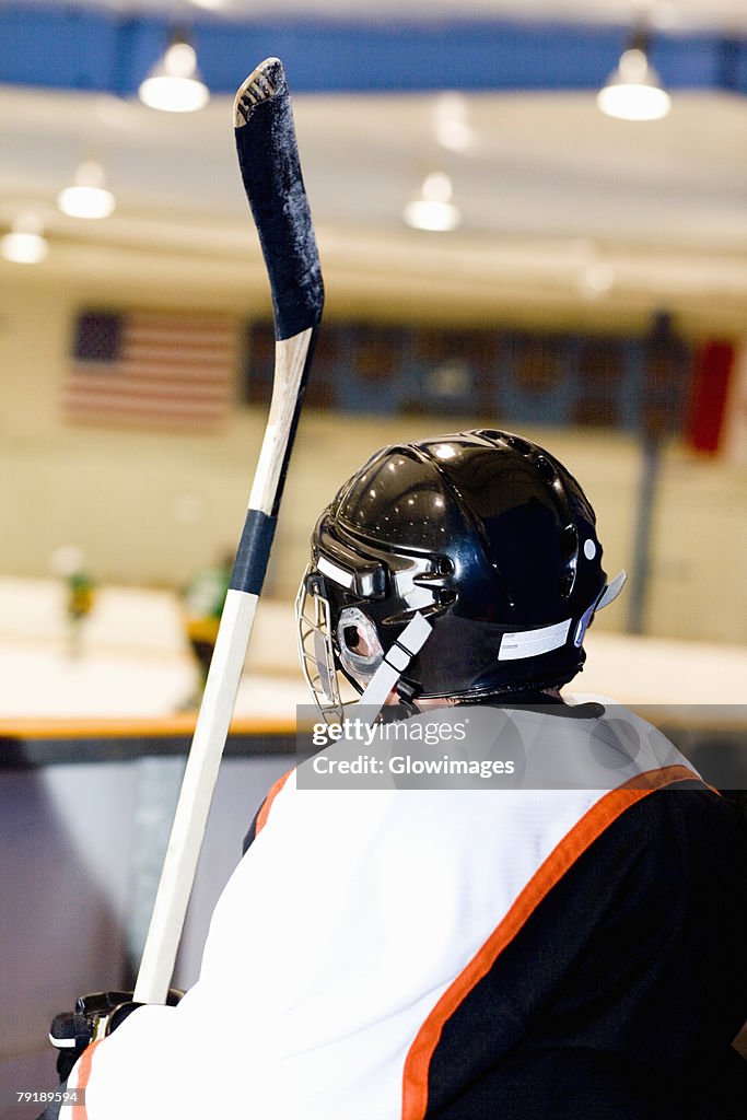 Rear view of an ice hockey player near an ice rink