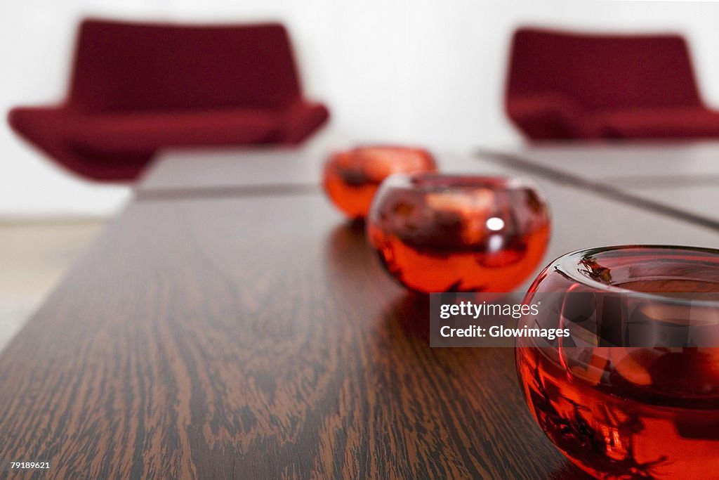 Close-up of candlestick holders in a row on a table