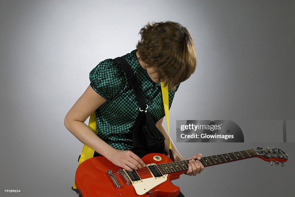 Close-up of a female guitarist playing a guitar