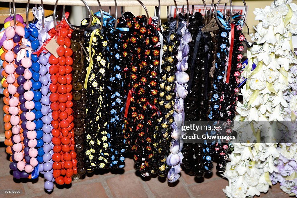 Close-up of garlands and necklaces hanging in a store