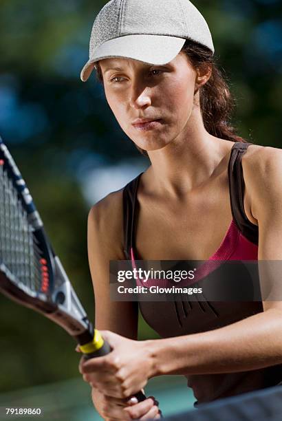 close-up of a young woman playing with a tennis racket - tennis raquet close up photos et images de collection