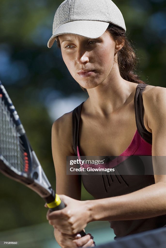 Close-up of a young woman playing with a tennis racket