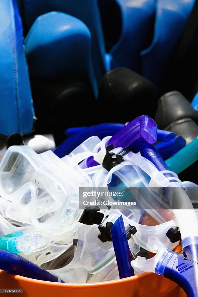 Snorkels and scuba masks in a bucket