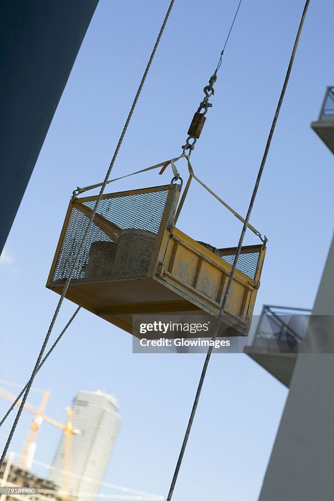 Container attached to the pulley of a lift